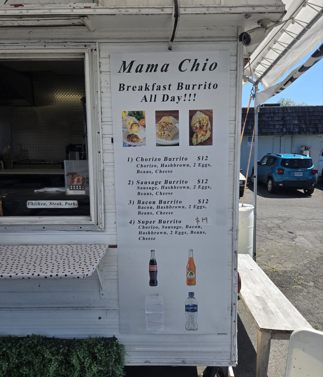 The white food cart features a menu board listing various breakfast burritos.
